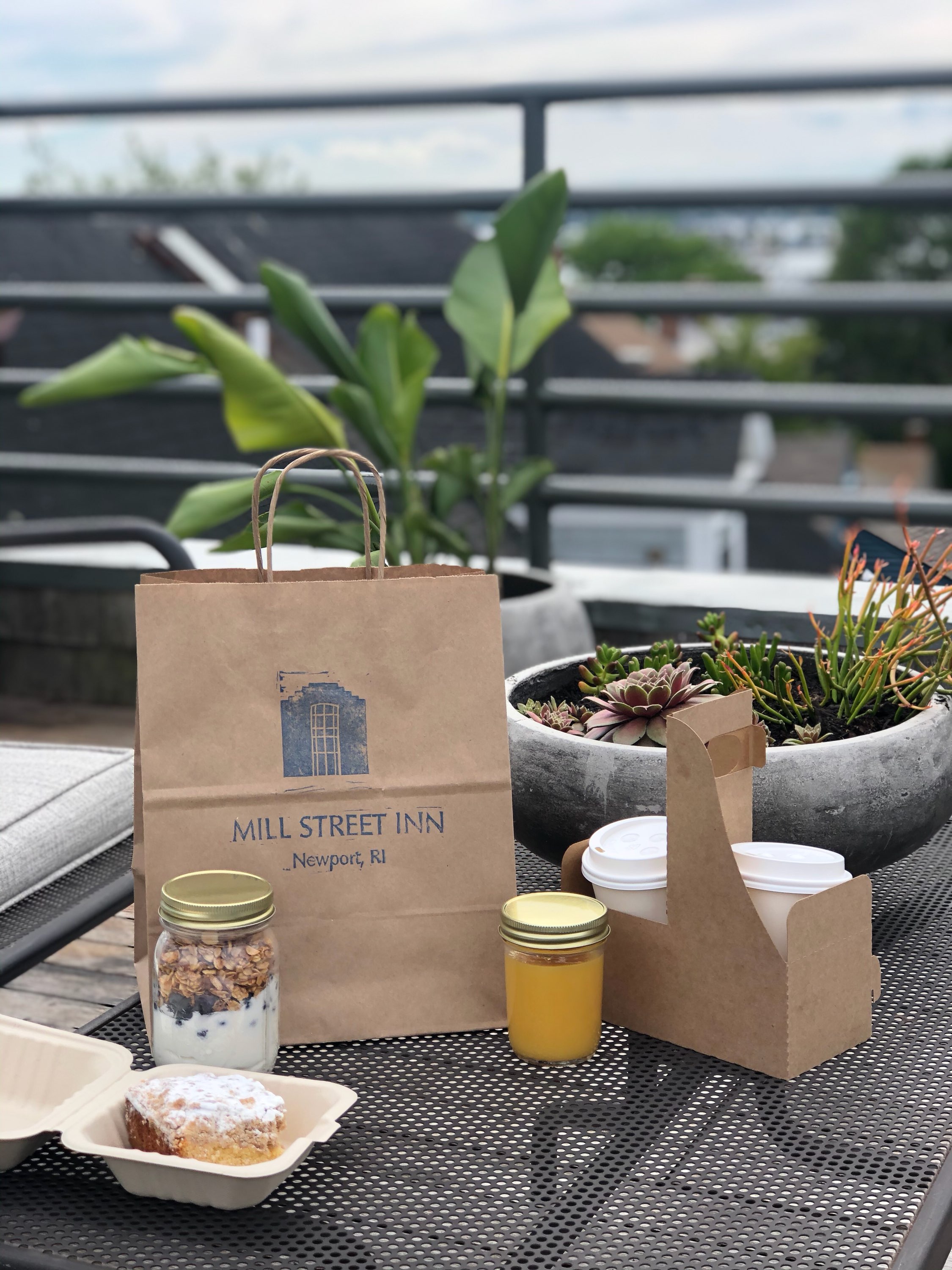 a table with a bag, food, and drinks on it